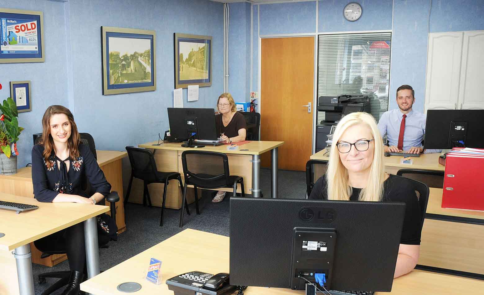 Group of workers in an office at desks